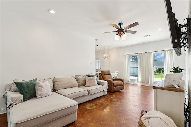 living area with a ceiling fan, visible vents, concrete flooring, and recessed lighting