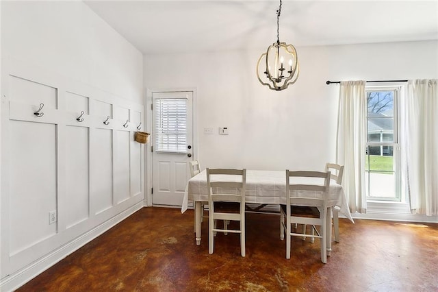 unfurnished dining area featuring concrete floors and a notable chandelier