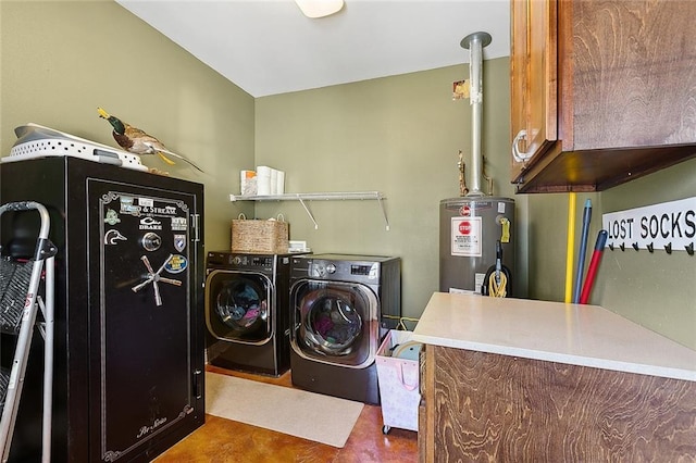 clothes washing area with water heater, cabinet space, and washer and clothes dryer