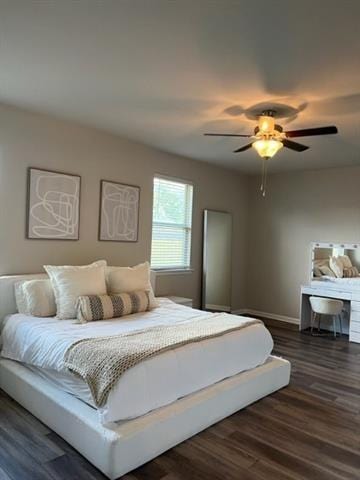 bedroom featuring wood finished floors, baseboards, and ceiling fan