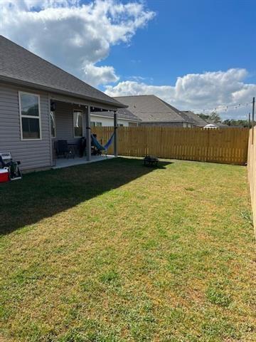 view of yard with a patio and a fenced backyard