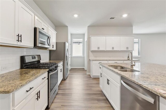 5635 Oak Trace Dr, Saint Gabriel, LA 70776 - kitchen with stainless steel appliances, a sink, white cabinets, and recessed lighting