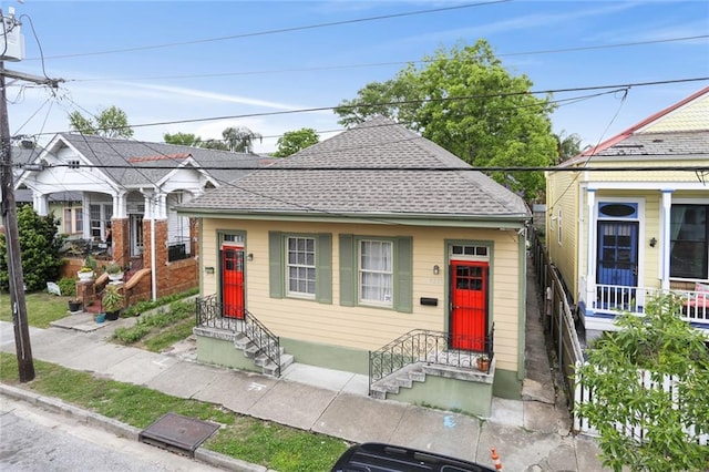 view of front facade featuring roof with shingles