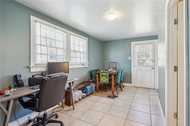 office space featuring baseboards and light tile patterned flooring