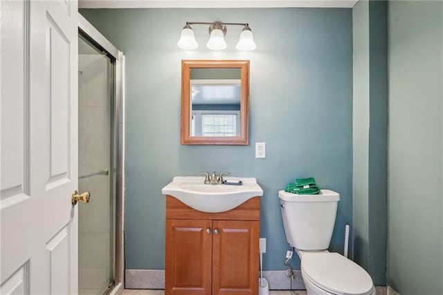 full bath featuring toilet, a stall shower, and vanity