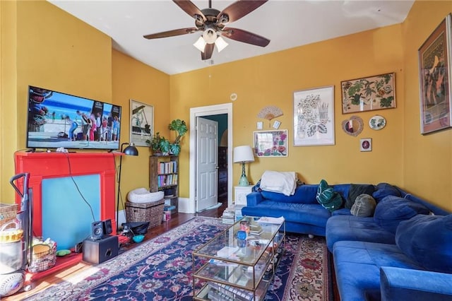 living room with ceiling fan and wood finished floors