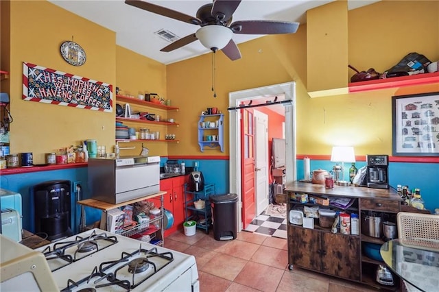 kitchen featuring ceiling fan, light tile patterned floors, white range with gas stovetop, visible vents, and open shelves