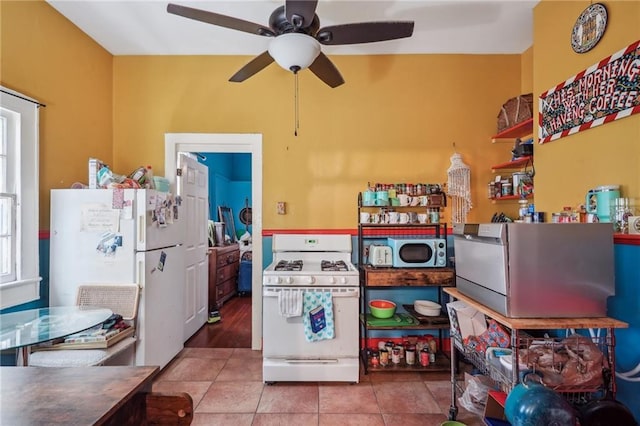 kitchen featuring ceiling fan, white appliances, and tile patterned floors