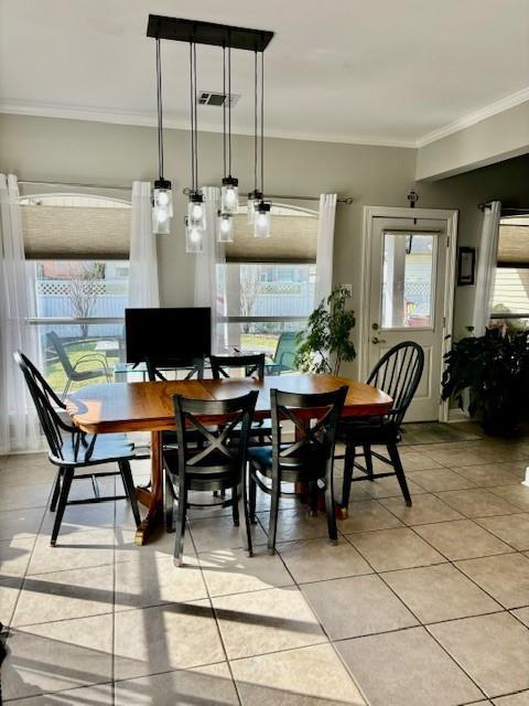 209 Legrande Bayou Ln, Kenner, LA 70065 - dining room featuring light tile patterned floors, ornamental molding, and visible vents