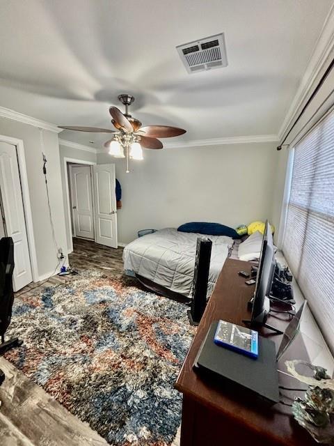 209 Legrande Bayou Ln, Kenner, LA 70065 - bedroom with ornamental molding, visible vents, ceiling fan, and wood finished floors