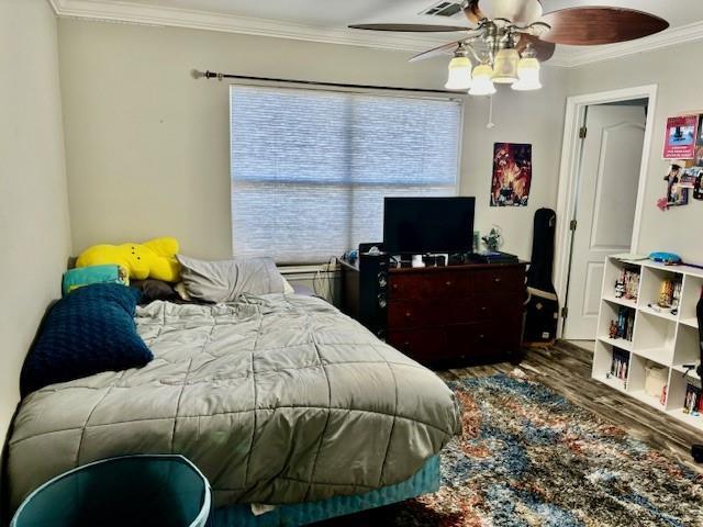 209 Legrande Bayou Ln, Kenner, LA 70065 - bedroom featuring ornamental molding, ceiling fan, and wood finished floors