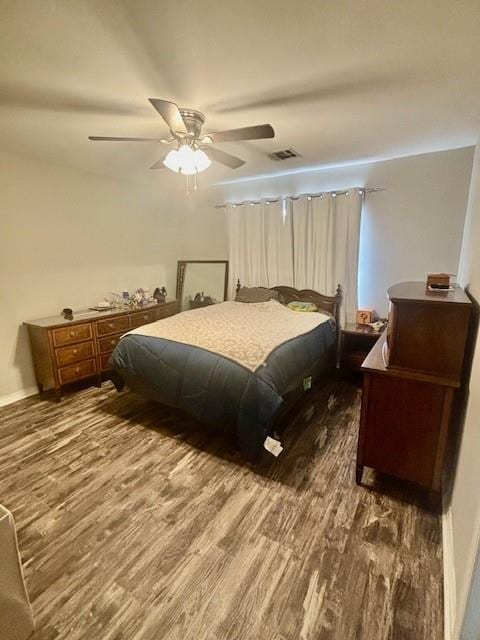 209 Legrande Bayou Ln, Kenner, LA 70065 - bedroom with baseboards, wood finished floors, visible vents, and a ceiling fan
