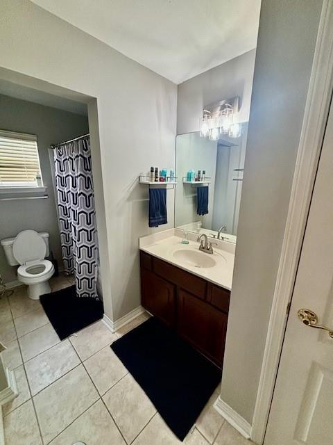 209 Legrande Bayou Ln, Kenner, LA 70065 - full bathroom featuring toilet, tile patterned flooring, vanity, and baseboards