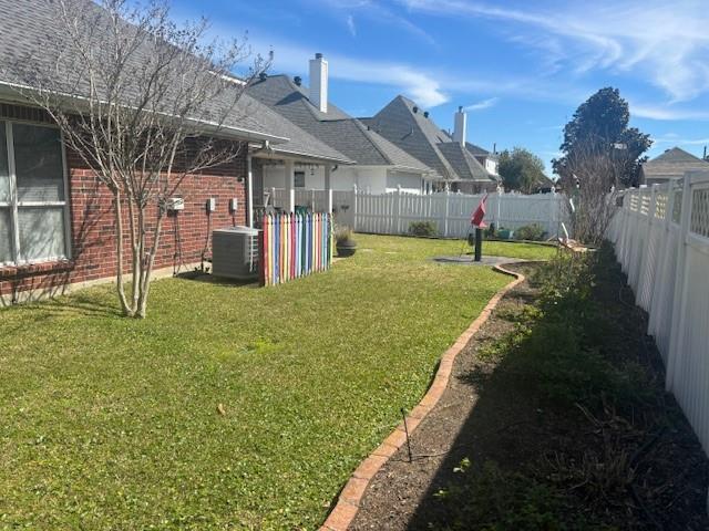209 Legrande Bayou Ln, Kenner, LA 70065 - view of yard featuring a fenced backyard and central AC unit