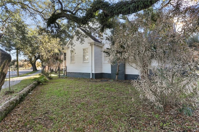 view of property exterior with a yard