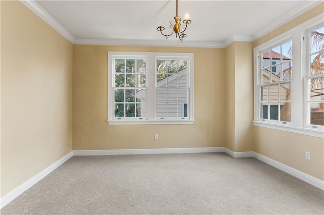 carpeted empty room featuring baseboards, ornamental molding, and an inviting chandelier