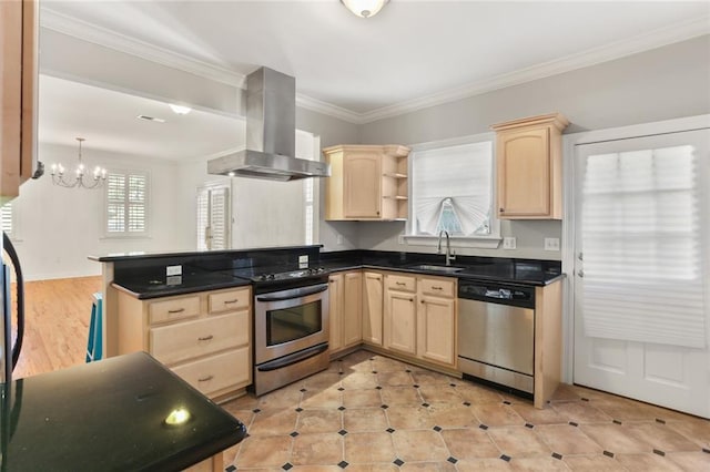 kitchen featuring appliances with stainless steel finishes, a peninsula, wall chimney range hood, light brown cabinets, and a sink