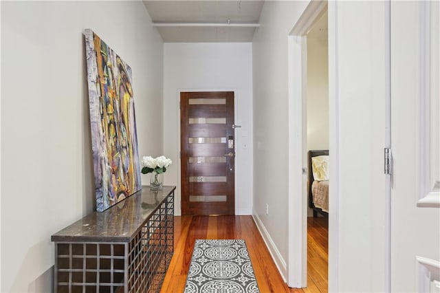 interior space with wood finished floors and baseboards