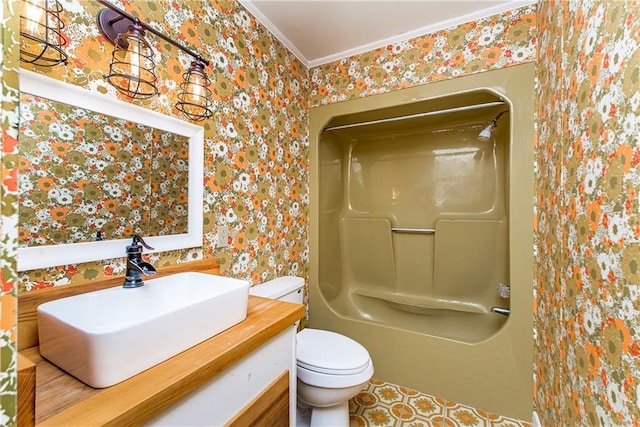 full bathroom with wallpapered walls, bathing tub / shower combination, toilet, crown molding, and vanity