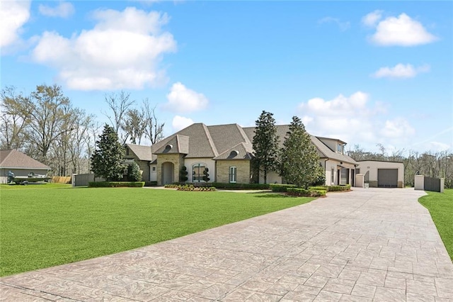 french country home featuring stone siding and a front lawn