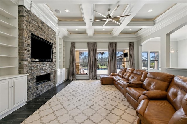 living room with dark wood-style flooring, a fireplace, coffered ceiling, ornamental molding, and beam ceiling