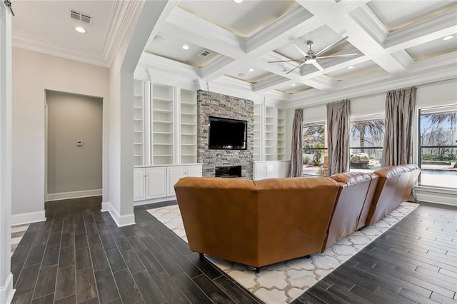 living room featuring beam ceiling, visible vents, baseboards, and wood finished floors