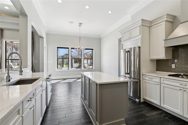 kitchen featuring decorative backsplash, dark wood-style floors, appliances with stainless steel finishes, custom exhaust hood, and a sink