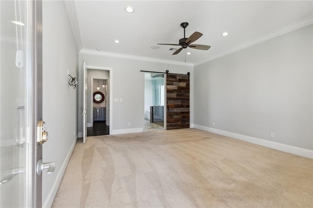 unfurnished bedroom featuring light carpet, a barn door, baseboards, ornamental molding, and recessed lighting