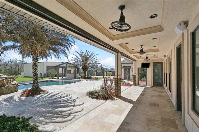 view of patio / terrace with ceiling fan and an outdoor pool