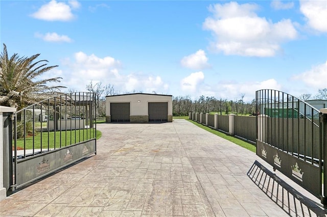 view of gate with fence and an outdoor structure