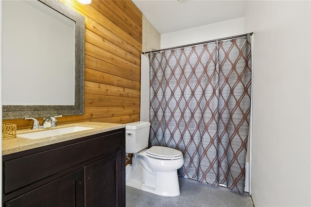 bathroom with a shower with curtain, vanity, toilet, and wooden walls