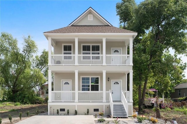 view of front of home featuring crawl space, covered porch, and a shingled roof