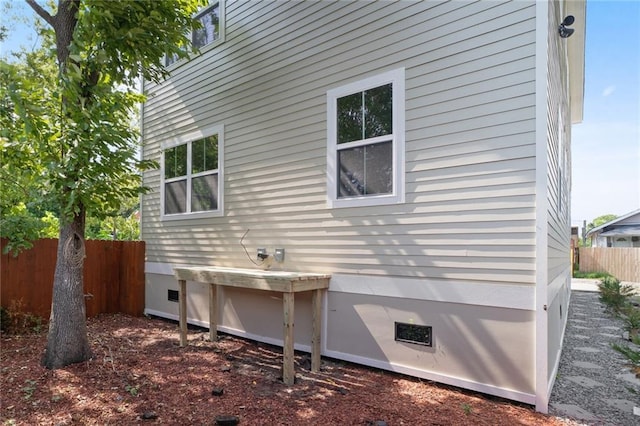 view of home's exterior with fence