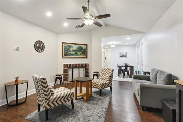 living room with vaulted ceiling with beams, dark wood-type flooring, visible vents, baseboards, and a brick fireplace