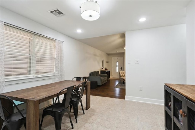 dining room with lofted ceiling, visible vents, baseboards, and recessed lighting