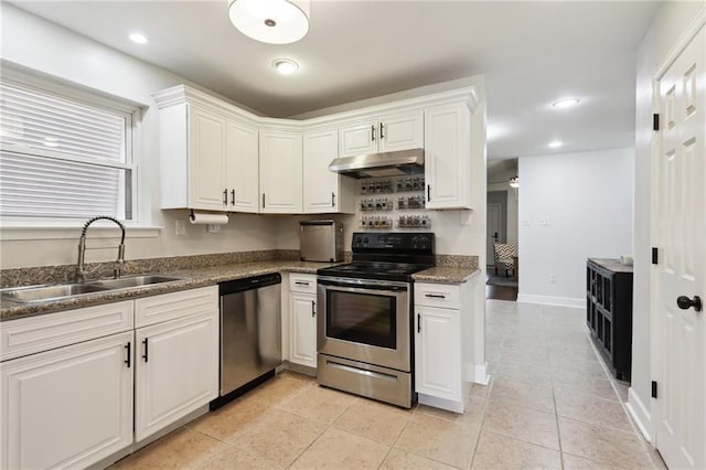 kitchen featuring light tile patterned floors, white cabinets, stainless steel appliances, under cabinet range hood, and a sink