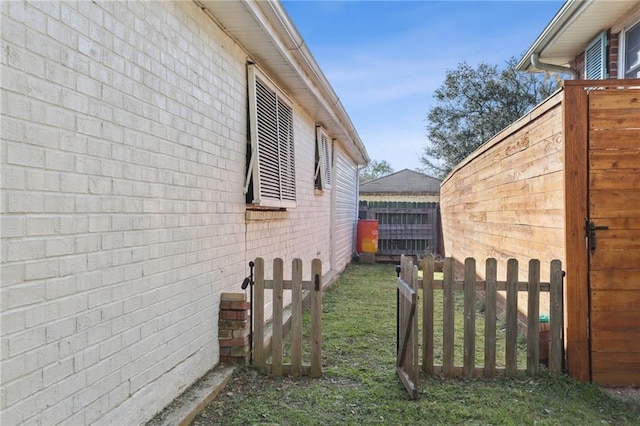 view of home's exterior featuring brick siding and fence