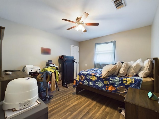 bedroom featuring ceiling fan, wood finished floors, and visible vents