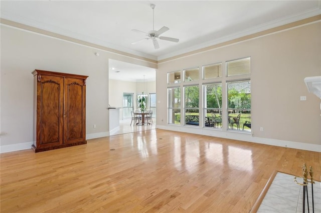 unfurnished living room with crown molding, plenty of natural light, a ceiling fan, and light wood-style floors