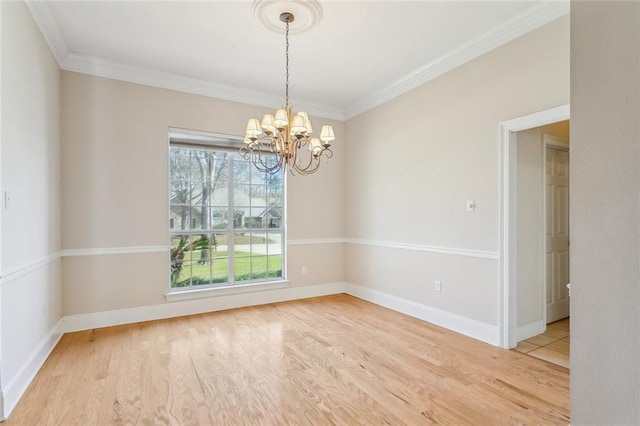 unfurnished room featuring baseboards, an inviting chandelier, wood finished floors, and ornamental molding