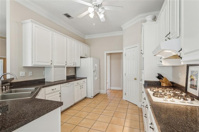 kitchen with a sink, under cabinet range hood, white appliances, crown molding, and ceiling fan