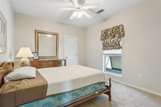 bedroom with visible vents, baseboards, light colored carpet, and a ceiling fan