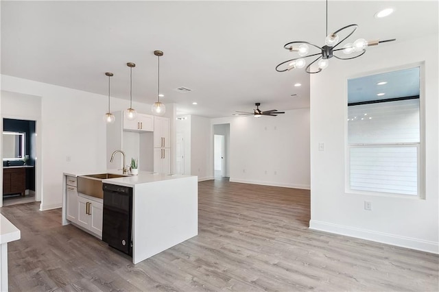 kitchen with dishwasher, light wood-style floors, a sink, and white cabinets