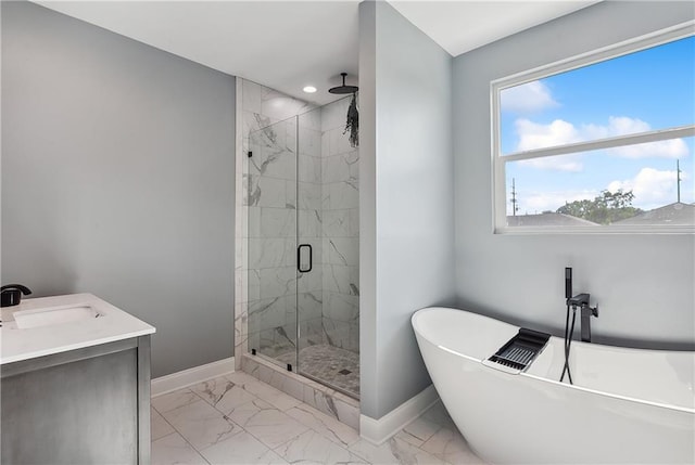 full bathroom featuring a freestanding bath, marble finish floor, a marble finish shower, and baseboards