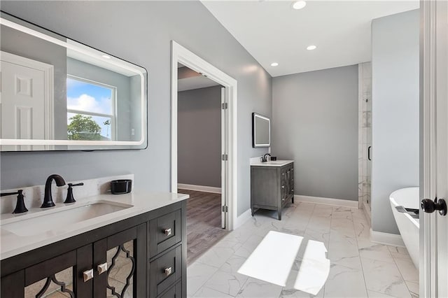 bathroom with recessed lighting, a sink, baseboards, marble finish floor, and a shower stall