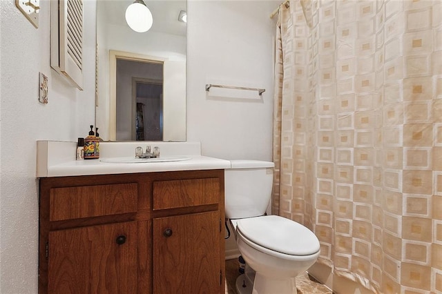 full bathroom featuring curtained shower, vanity, and toilet