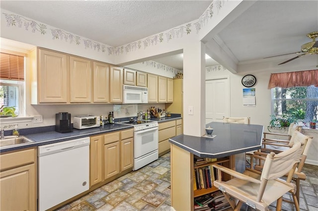 108 Bertel Dr, Covington, LA 70433 - kitchen with a ceiling fan, stone finish floor, dark countertops, and white appliances