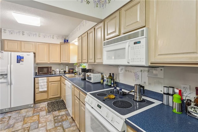 108 Bertel Dr, Covington, LA 70433 - kitchen featuring white appliances, stone finish floor, a textured ceiling, dark countertops, and light brown cabinets