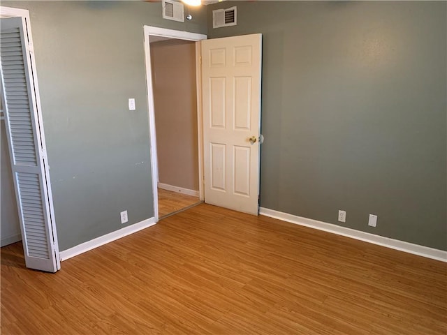 unfurnished bedroom featuring light wood-style flooring, visible vents, and baseboards