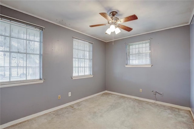 spare room with ornamental molding, plenty of natural light, and carpet flooring